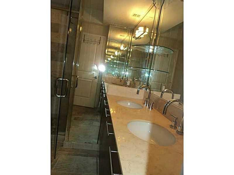 2681 North Flamingo Road, Unit 2604S Plantation, FL 33323 - Photo 12 of 16 a bathroom with a sink and mirror