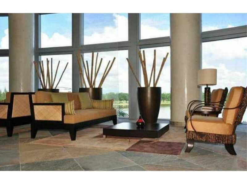 2681 North Flamingo Road, Unit 2604S Plantation, FL 33323 - Photo 4 of 16 a living room with furniture and a floor to ceiling window