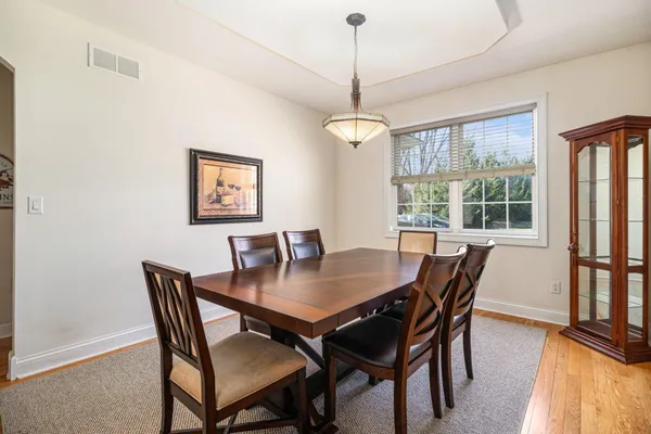 a view of a dining room with furniture window and wooden floor