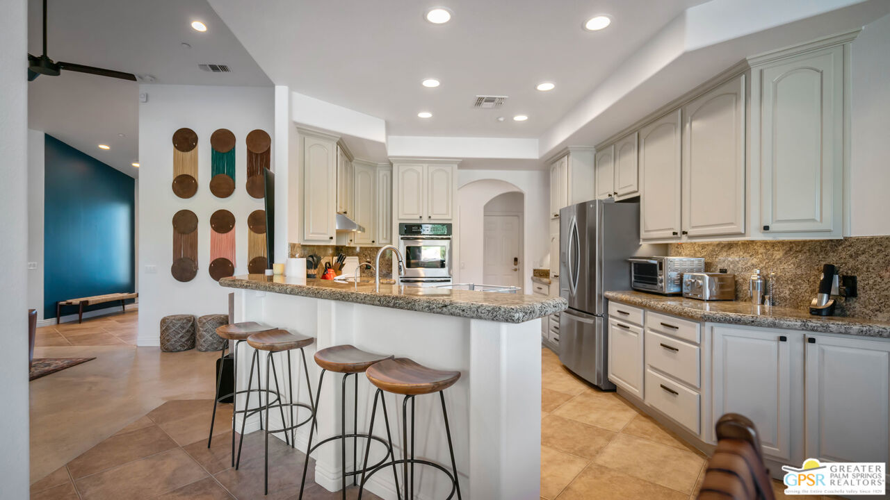 7514 Sunset Road Joshua Tree, CA 92252 - Photo 20 of 69 a kitchen with stainless steel appliances granite countertop a sink and a refrigerator