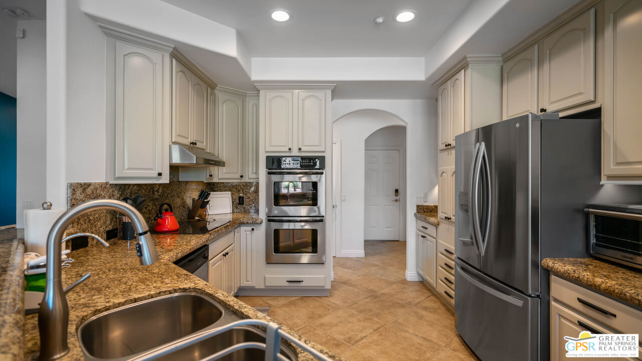 7514 Sunset Road Joshua Tree, CA 92252 - Photo 21 of 69 a kitchen with stainless steel appliances granite countertop a sink stove and refrigerator