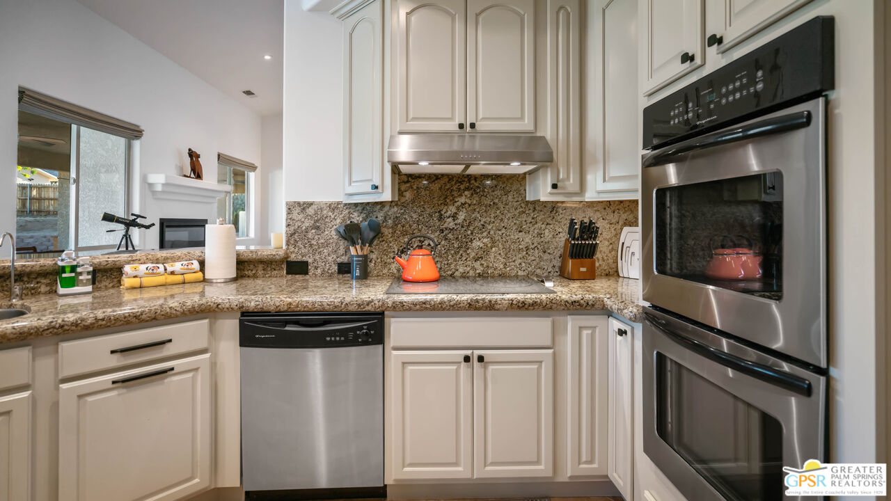 7514 Sunset Road Joshua Tree, CA 92252 - Photo 23 of 69 a kitchen with stainless steel appliances granite countertop a stove a sink and a microwave