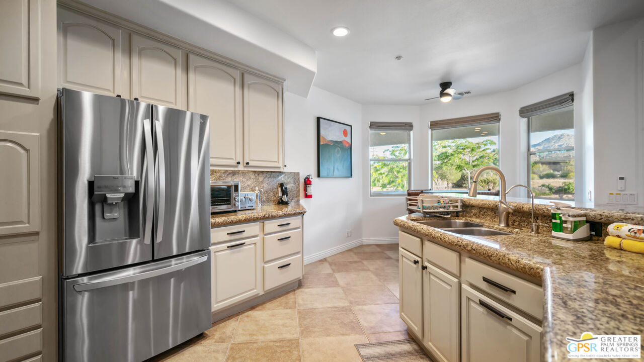 7514 Sunset Road Joshua Tree, CA 92252 - Photo 25 of 69 a kitchen with stainless steel appliances granite countertop a sink stove and refrigerator