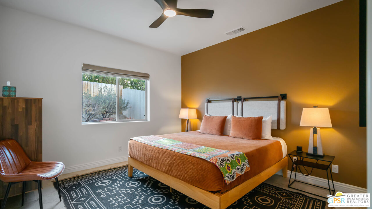 7514 Sunset Road Joshua Tree, CA 92252 - Photo 27 of 69 a bedroom with a bed and wooden floor