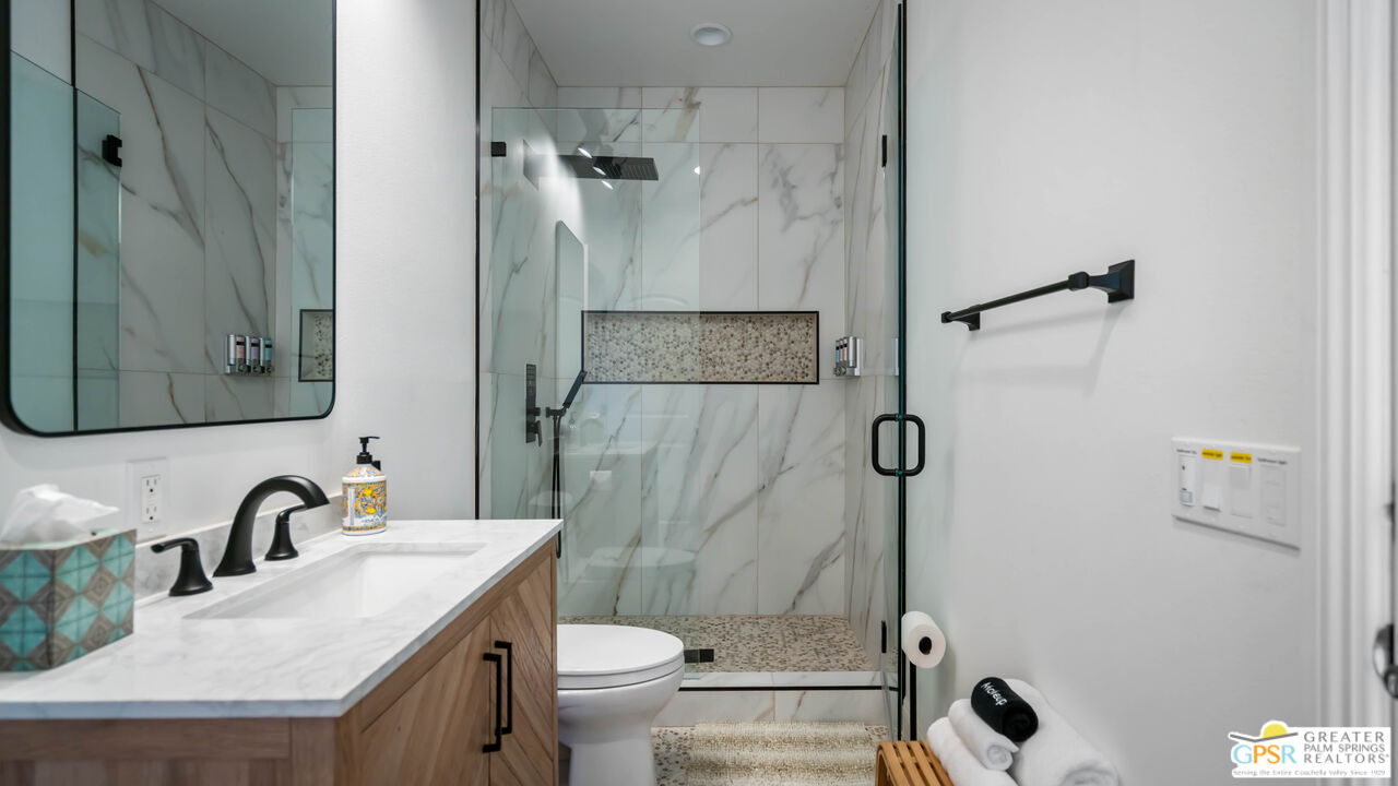 7514 Sunset Road Joshua Tree, CA 92252 - Photo 31 of 69 a bathroom with a granite countertop sink toilet and shower
