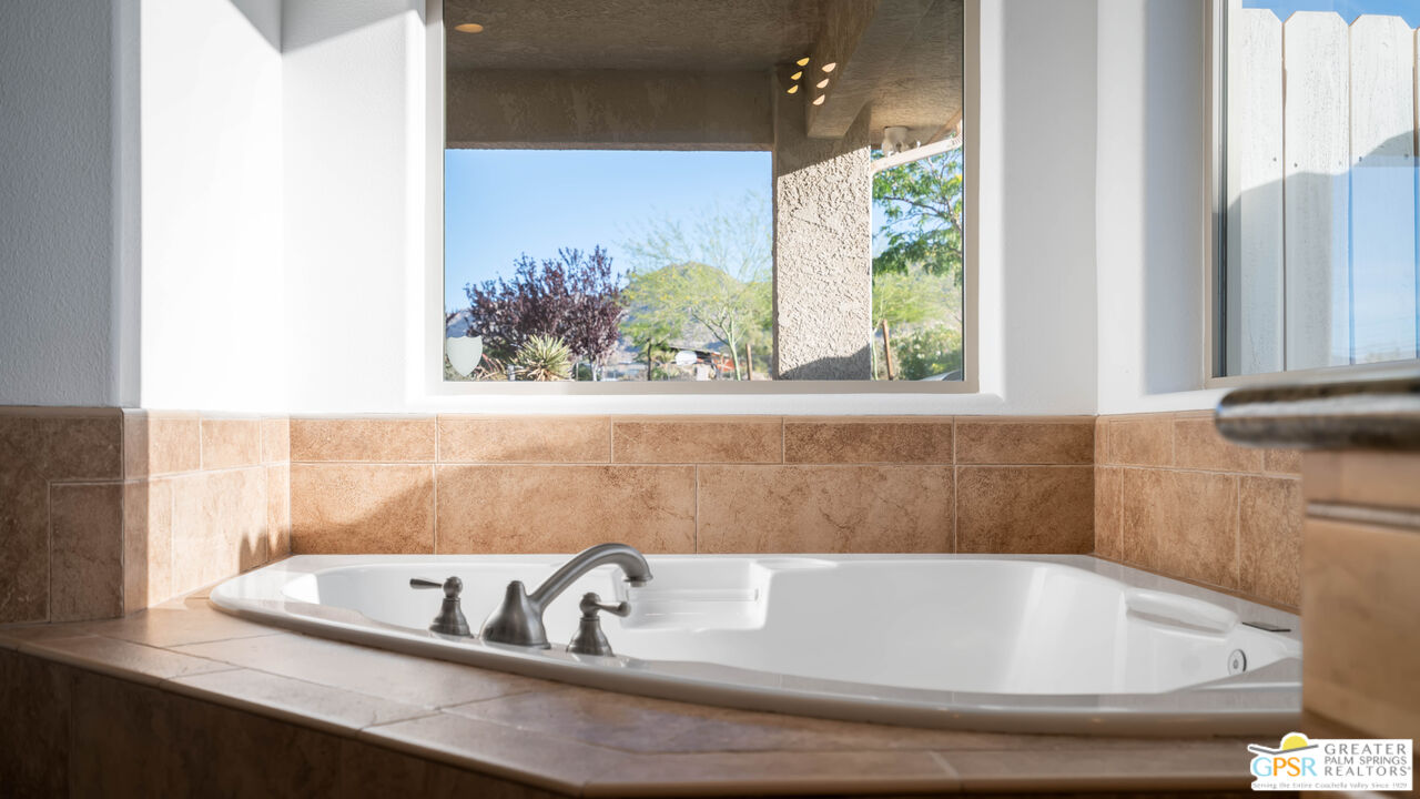 7514 Sunset Road Joshua Tree, CA 92252 - Photo 37 of 69 a bath tub sitting in a bathroom next to a window
