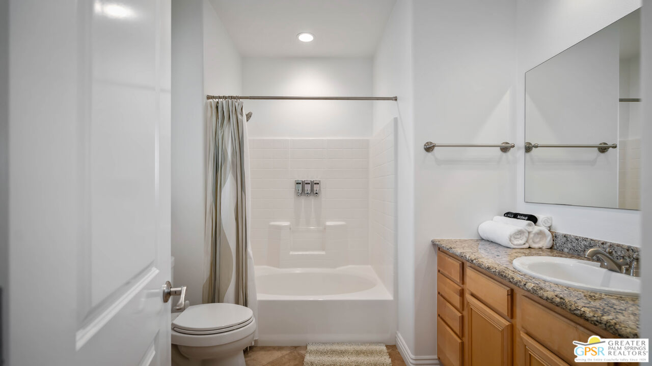 7514 Sunset Road Joshua Tree, CA 92252 - Photo 40 of 69 a bathroom with a granite countertop sink toilet and shower