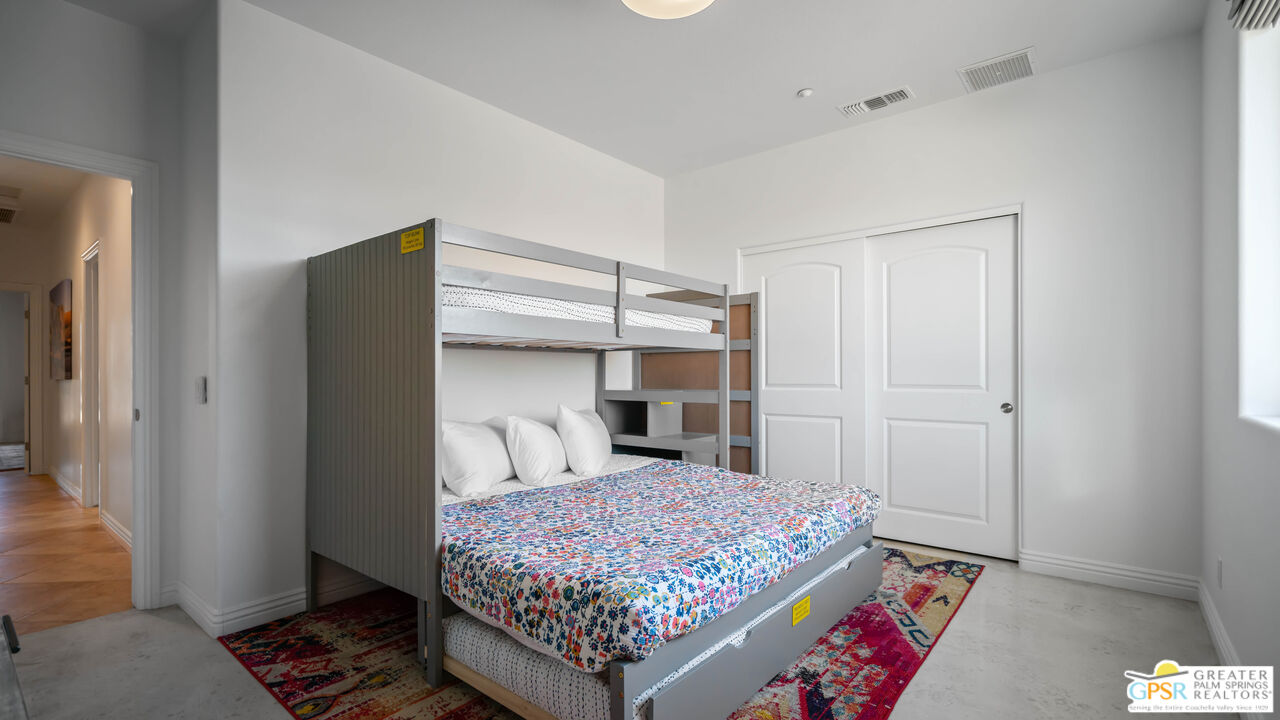 7514 Sunset Road Joshua Tree, CA 92252 - Photo 42 of 69 a bedroom with a bed and a window