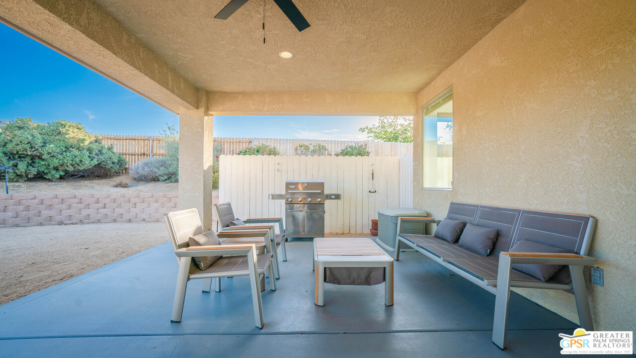 7514 Sunset Road Joshua Tree, CA 92252 - Photo 44 of 69 a living room with furniture and a large window