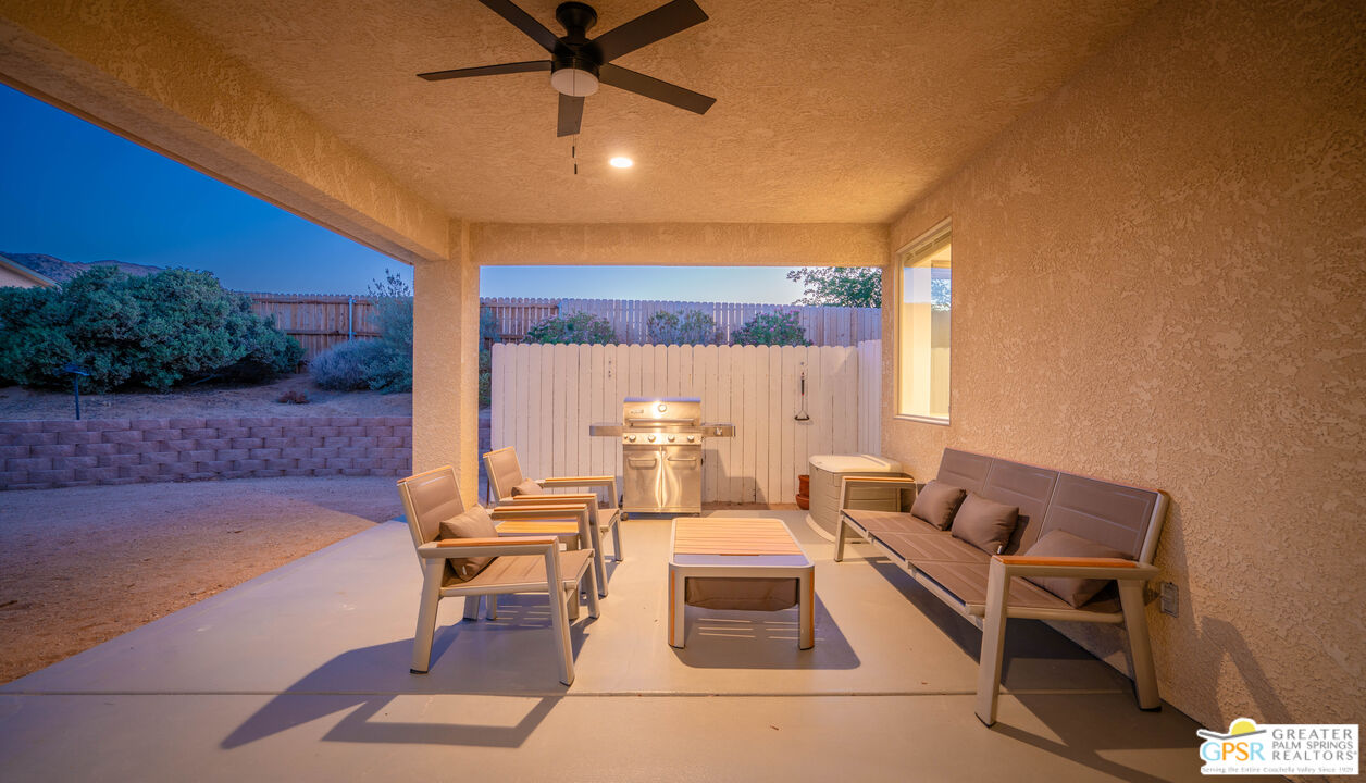 7514 Sunset Road Joshua Tree, CA 92252 - Photo 51 of 69 a living room with furniture and a large window