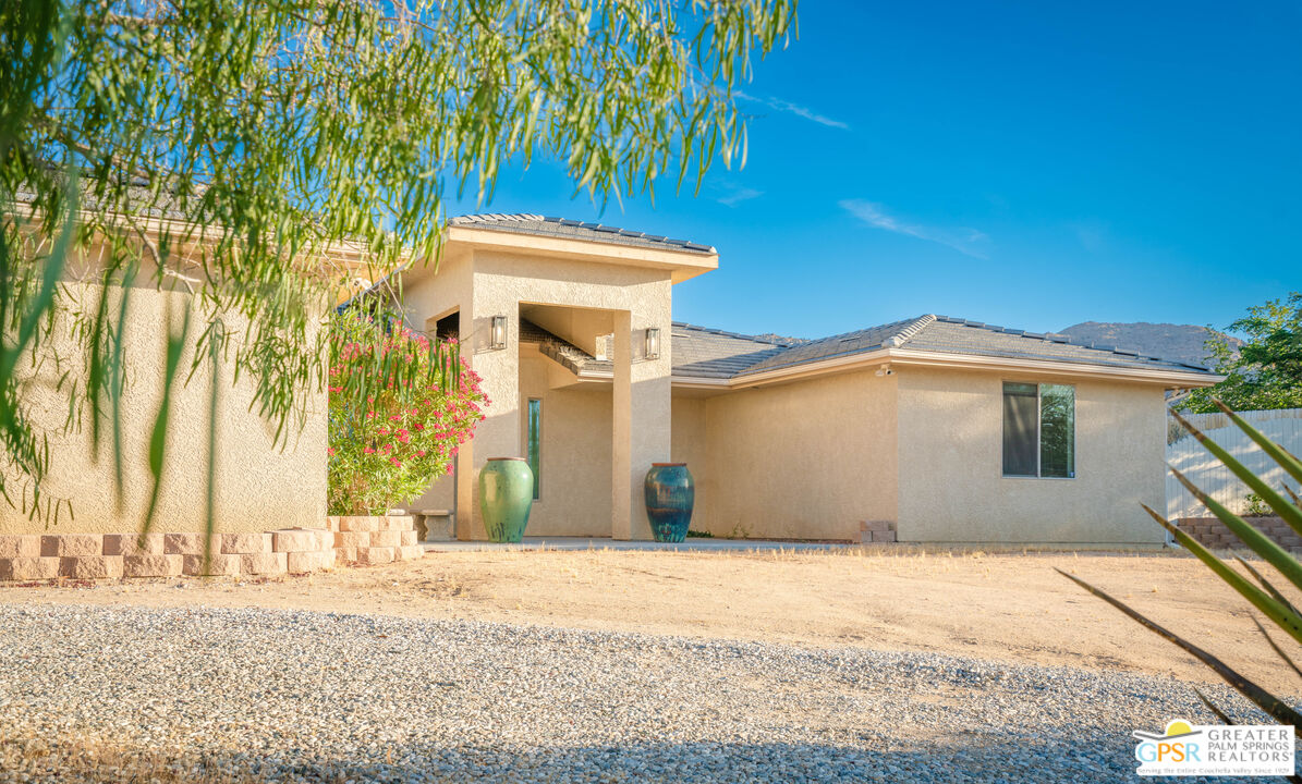 7514 Sunset Road Joshua Tree, CA 92252 - Photo 57 of 69 a front view of a house with a yard