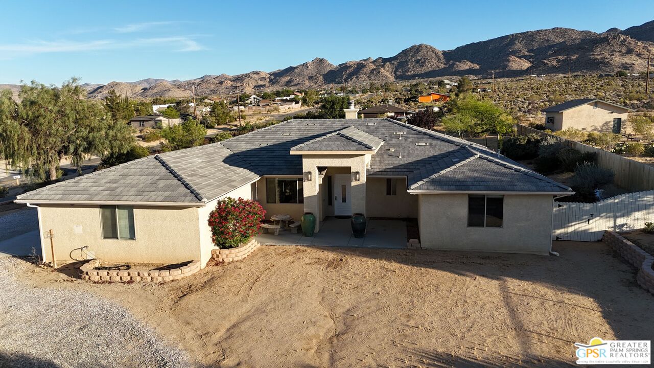 7514 Sunset Road Joshua Tree, CA 92252 - Photo 67 of 69 a front view of a house with a yard and mountain view in back
