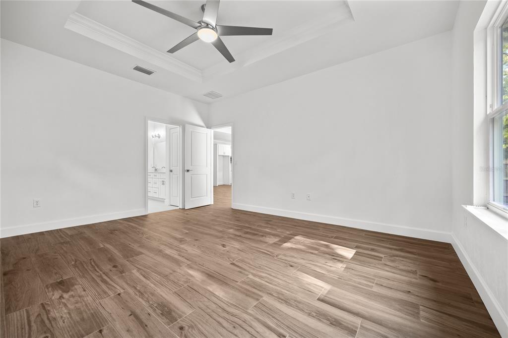 1086 Southwest 67th Drive Gainesville, FL 32607 - Photo 10 of 37 a view of empty room with wooden floor and fan