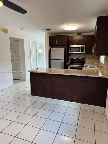 a kitchen with stainless steel appliances a sink and a counter top