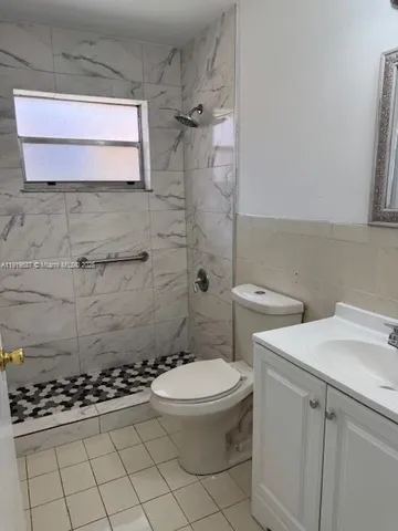 a bathroom with a sink a toilet and a shower