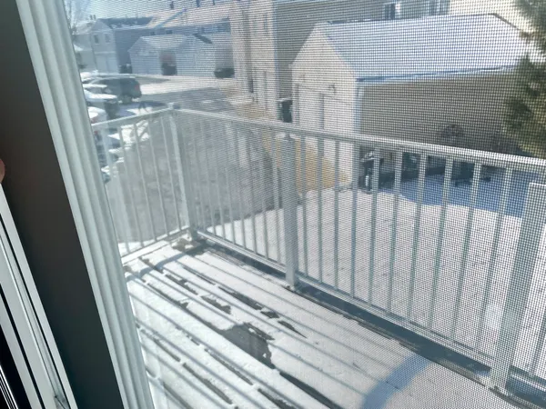 a view of a balcony with wooden floor