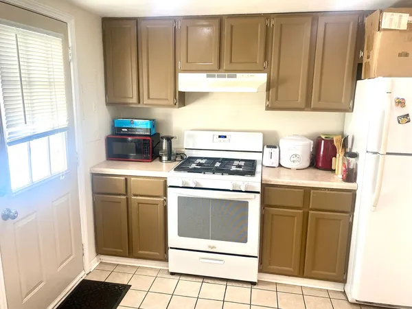a kitchen with appliances cabinets and a window