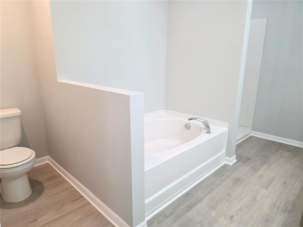 729 Chatham Walk Drive Ruskin, FL 33570 - Photo 12 of 15 a white toilet sitting next to a white tub