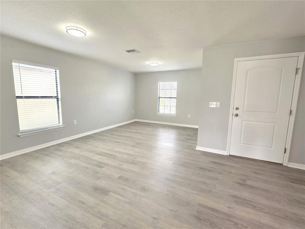 729 Chatham Walk Drive Ruskin, FL 33570 - Photo 2 of 15 an empty room with wooden floor and windows