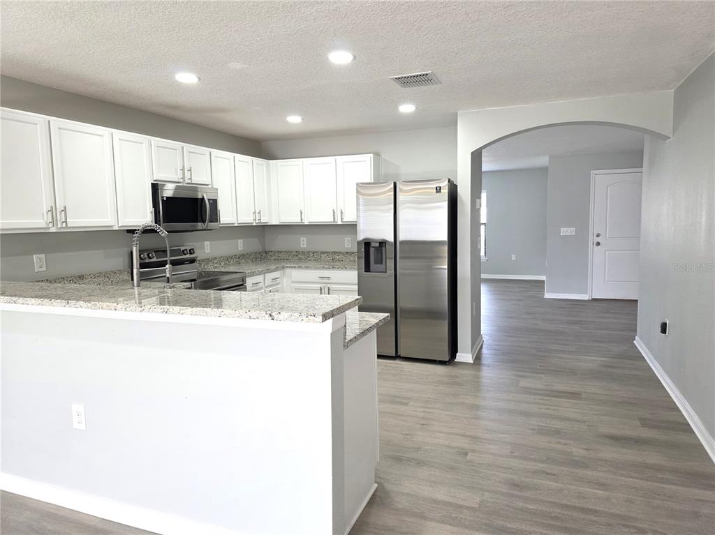 729 Chatham Walk Drive Ruskin, FL 33570 - Photo 6 of 15 a kitchen with stainless steel appliances granite countertop a refrigerator and a stove