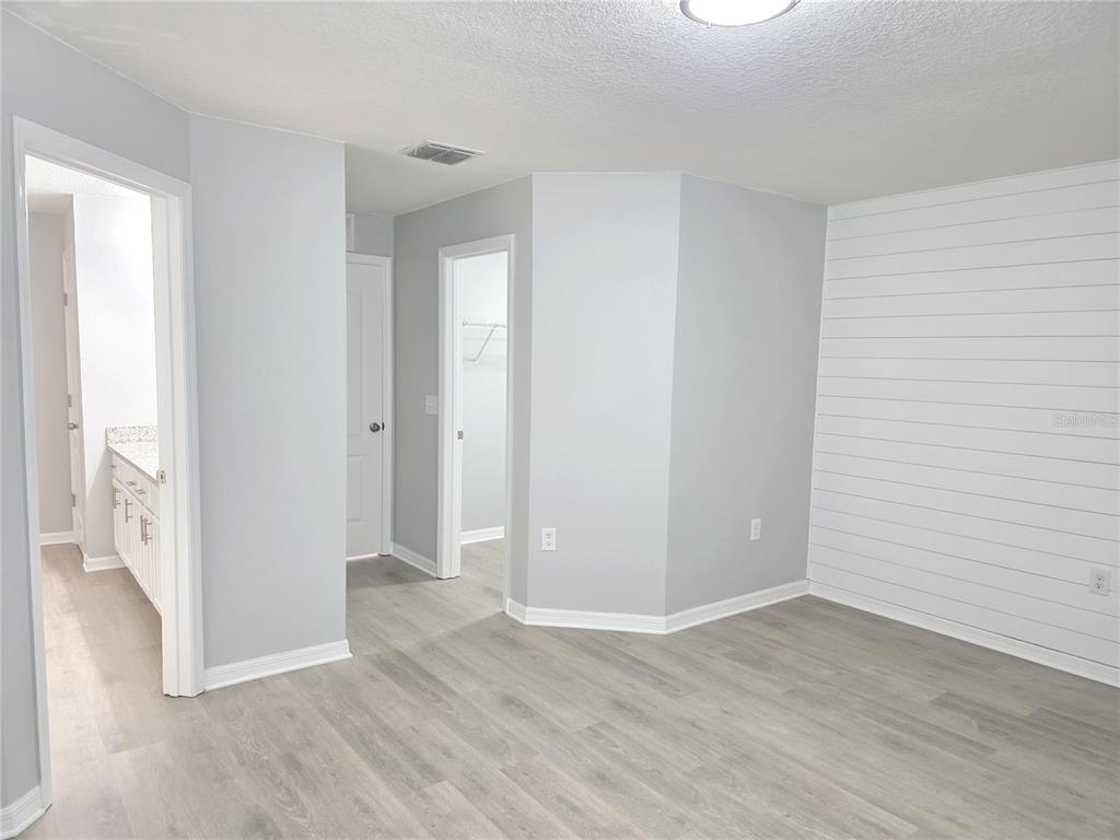 729 Chatham Walk Drive Ruskin, FL 33570 - Photo 8 of 15 a view of an empty room with wooden floor