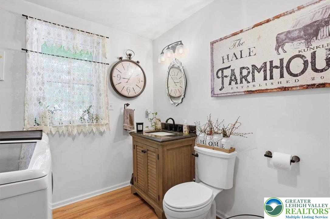 4880 Little Gap Road Kunkletown, PA 18058 - Photo 40 of 100 This bright bathroom features a classic vanity and wood flooring, offering a comfortable space.