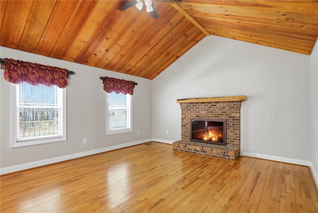196 Flyroot Trail Pickens, SC 29671 - Photo 14 of 48 This bright living space features wood floors, a cozy fireplace, and vaulted ceilings.
