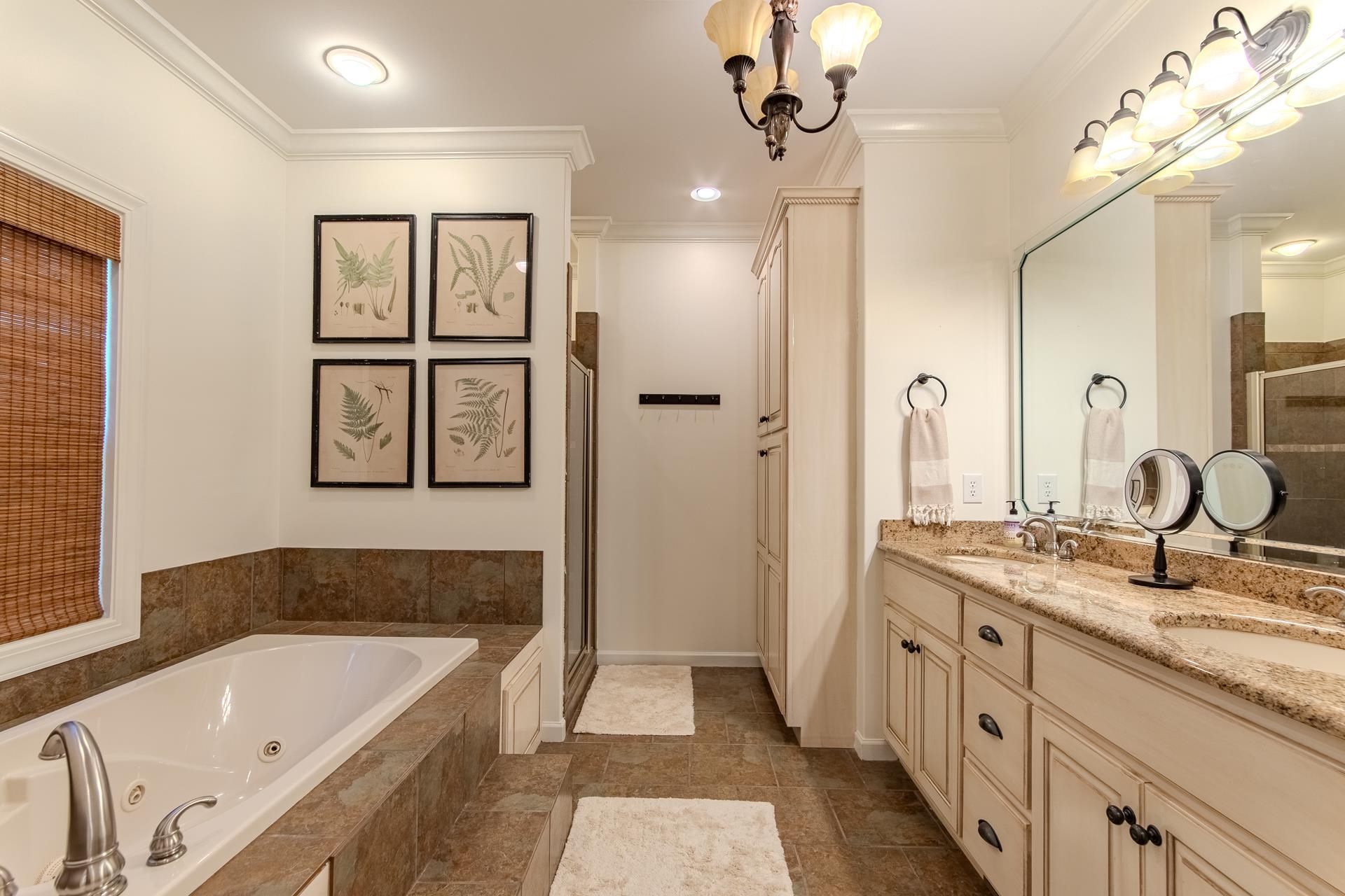 120 Pier Point Savannah, TN 38372 - Photo 23 of 38 Full bath with a jetted tub, double vanity, a stall shower, a chandelier, and ornamental molding