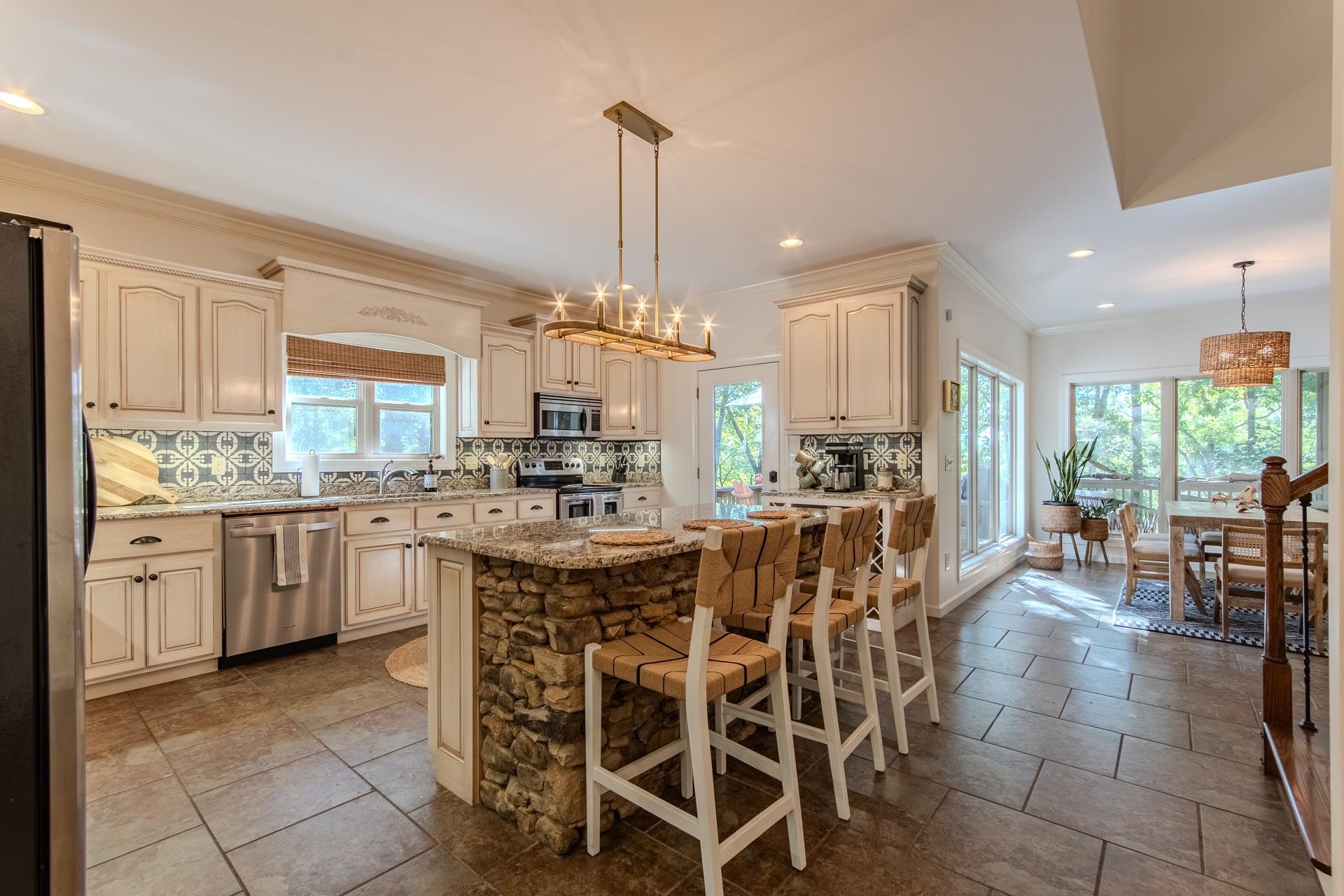 120 Pier Point Savannah, TN 38372 - Photo 8 of 38 Kitchen featuring a chandelier, cream cabinets, crown molding, decorative backsplash, and a kitchen bar