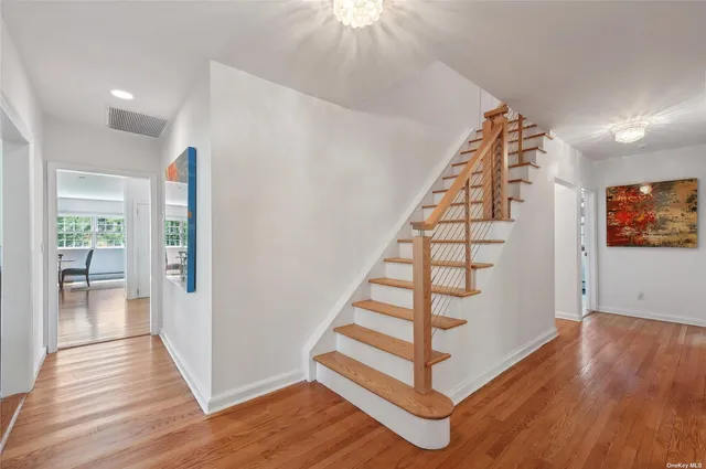 a view of entryway with wooden floor and stairs