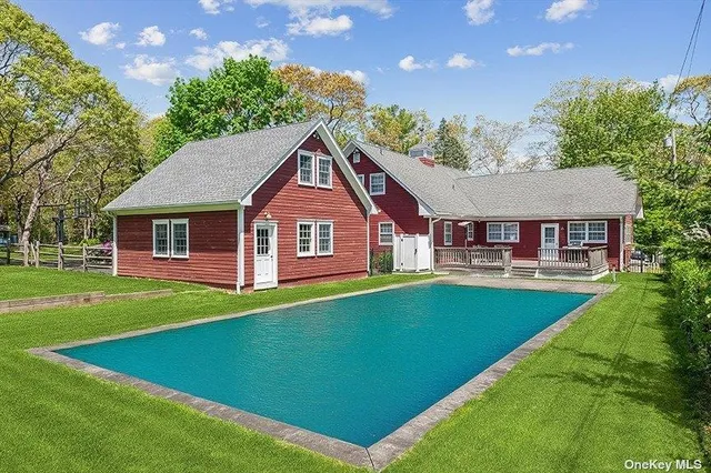 a aerial view of a house with swimming pool and deck