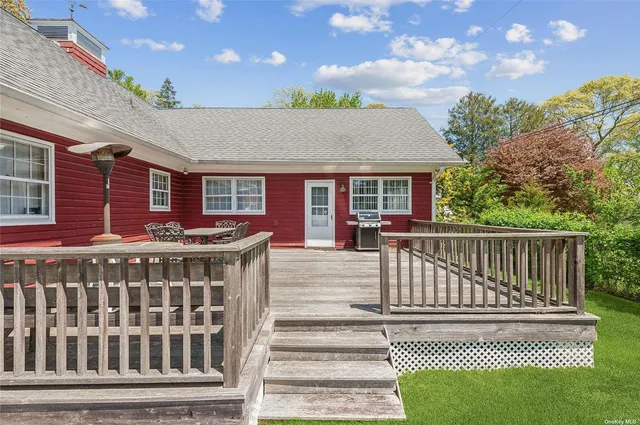 a view of a brick house with a deck