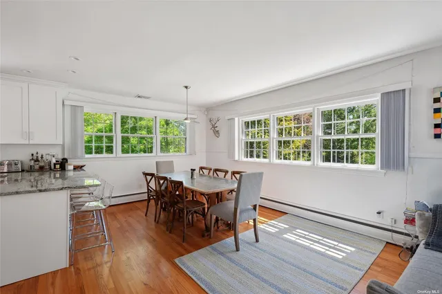 a view of a dining room with furniture window and wooden floor