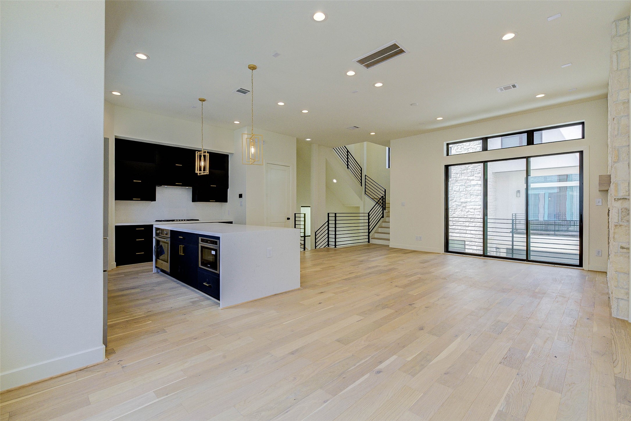 1803 Dunlavy Street Houston, TX 77006 - Photo 11 of 35 a view of kitchen with stainless steel appliances kitchen island wooden floor and window