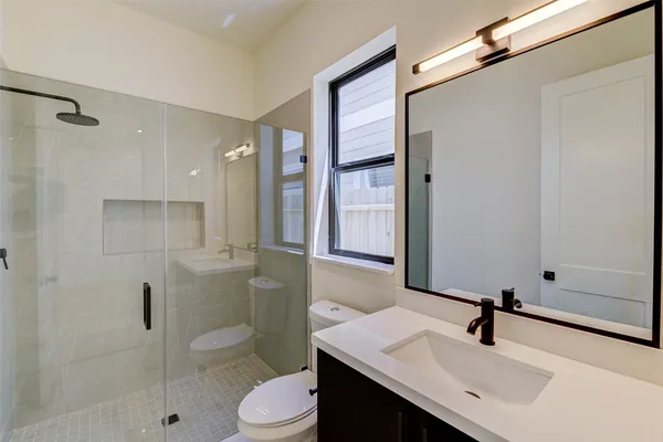 a bathroom with a shower and a toilet