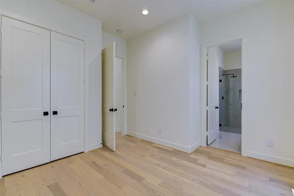 a spacious bathroom with a double vanity sink toilet mirror and bathtub