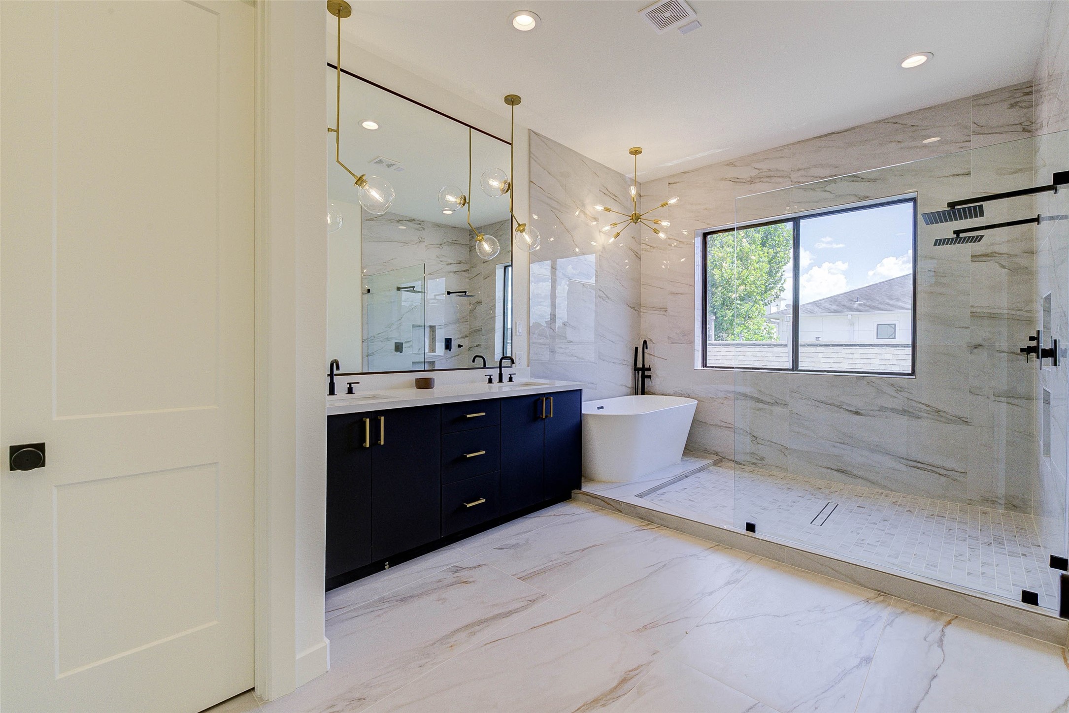 1803 Dunlavy Street Houston, TX 77006 - Photo 24 of 35 a spacious bathroom with a double vanity sink toilet mirror and bathtub
