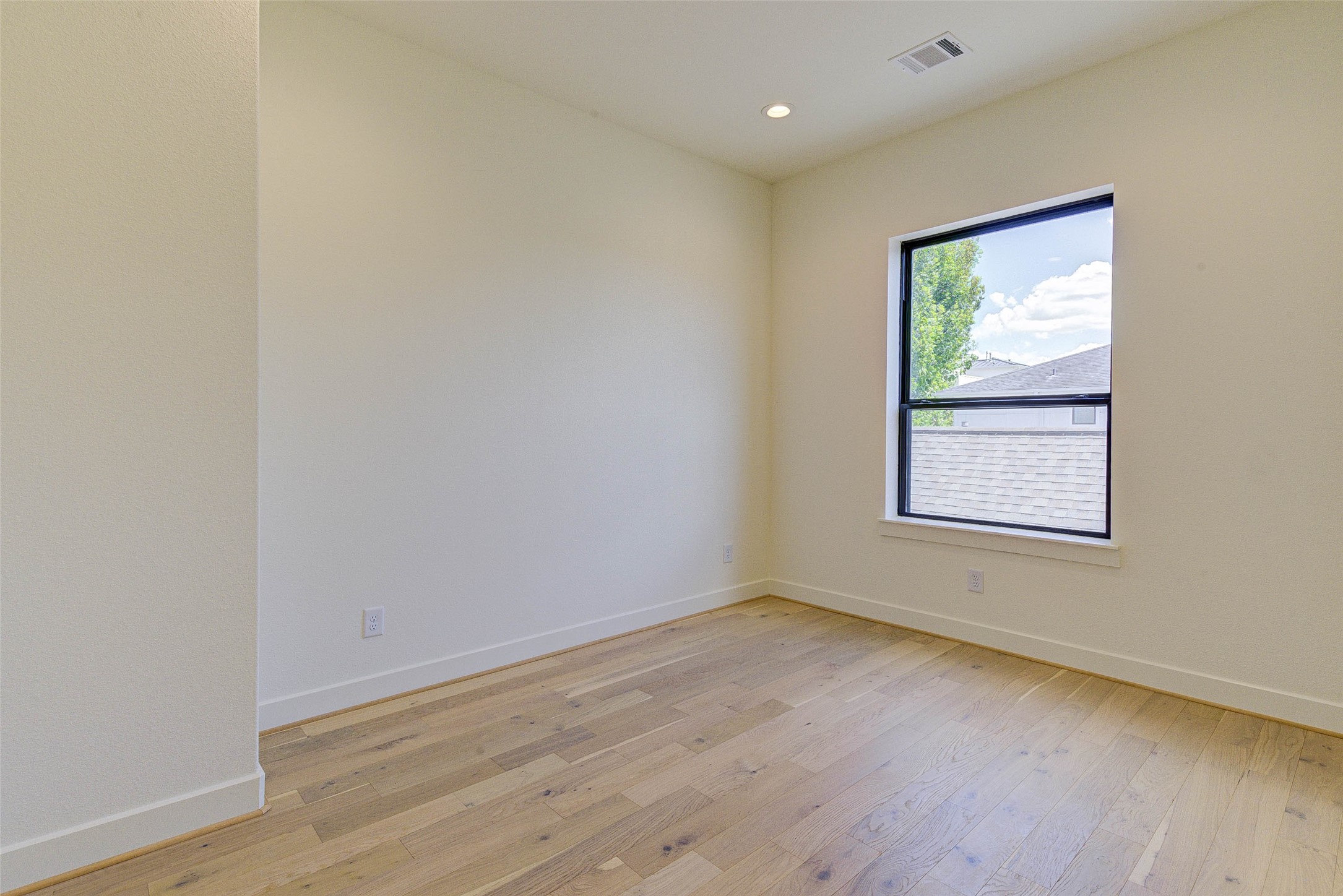 1803 Dunlavy Street Houston, TX 77006 - Photo 27 of 35 a view of an empty room with wooden floor and a window
