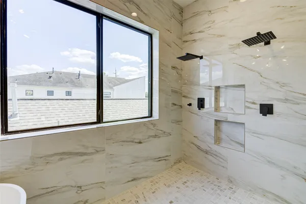 a white bath tub sitting next to a white sink
