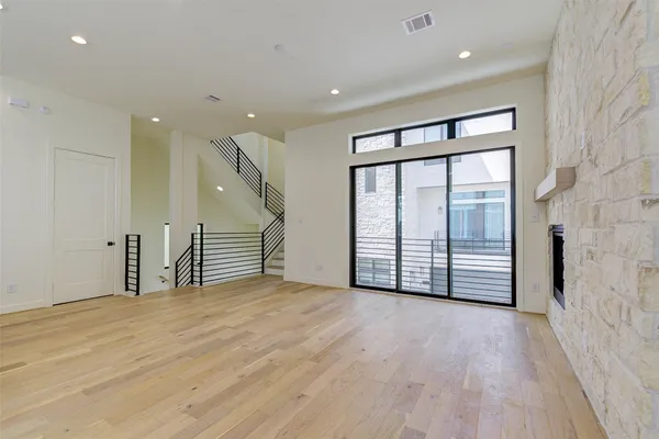 a view of kitchen with stainless steel appliances kitchen island wooden floor and window