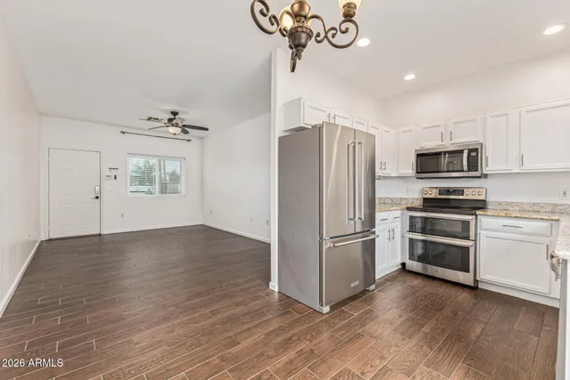 a kitchen with a refrigerator cabinets and stainless steel appliances