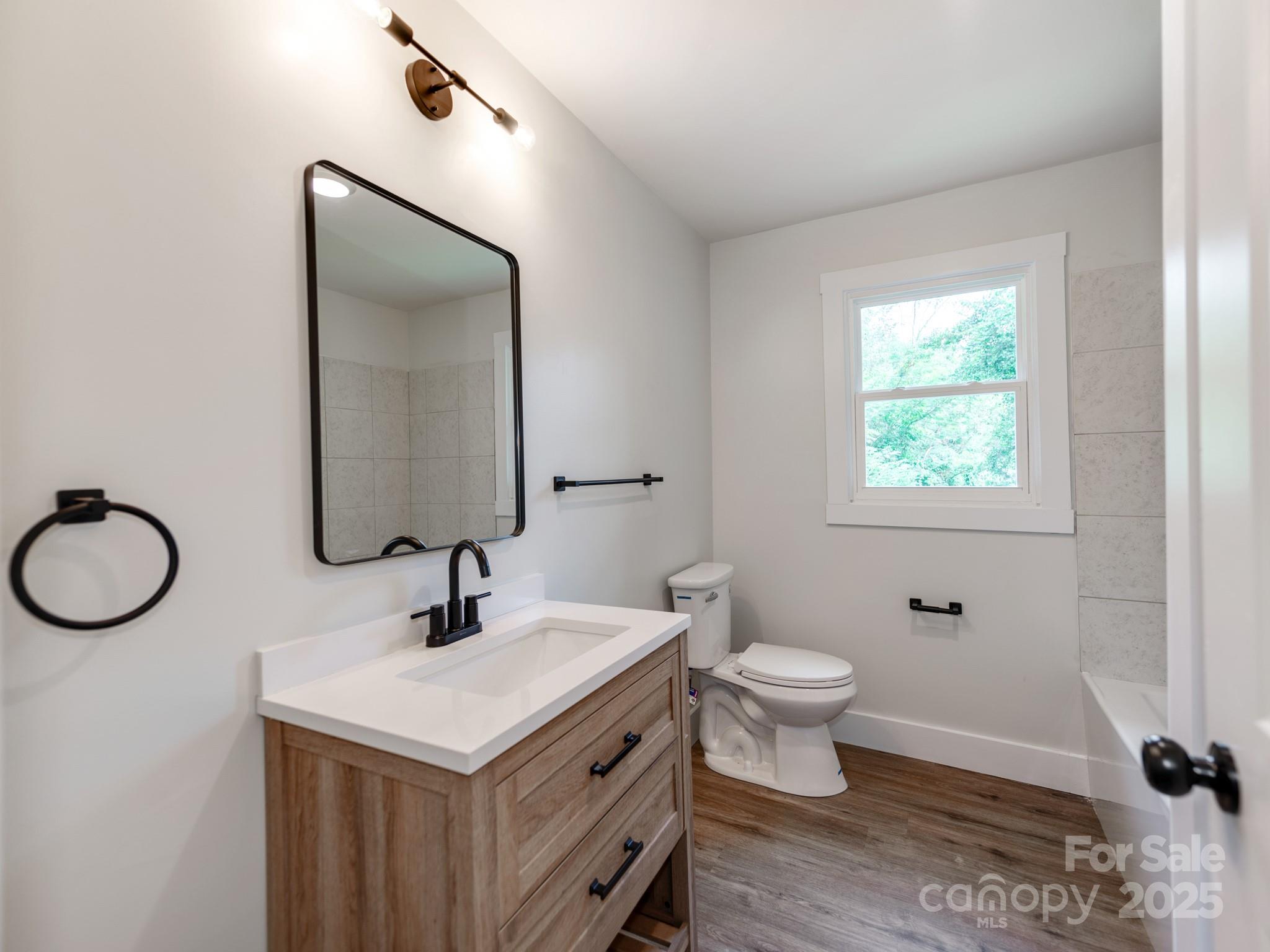 5404 Hope Road Vale, NC 28168 - Photo 17 of 28 a bathroom with a toilet sink and a mirror