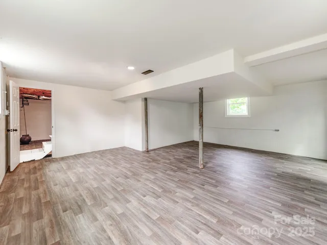 a view of a livingroom with wooden floor and window