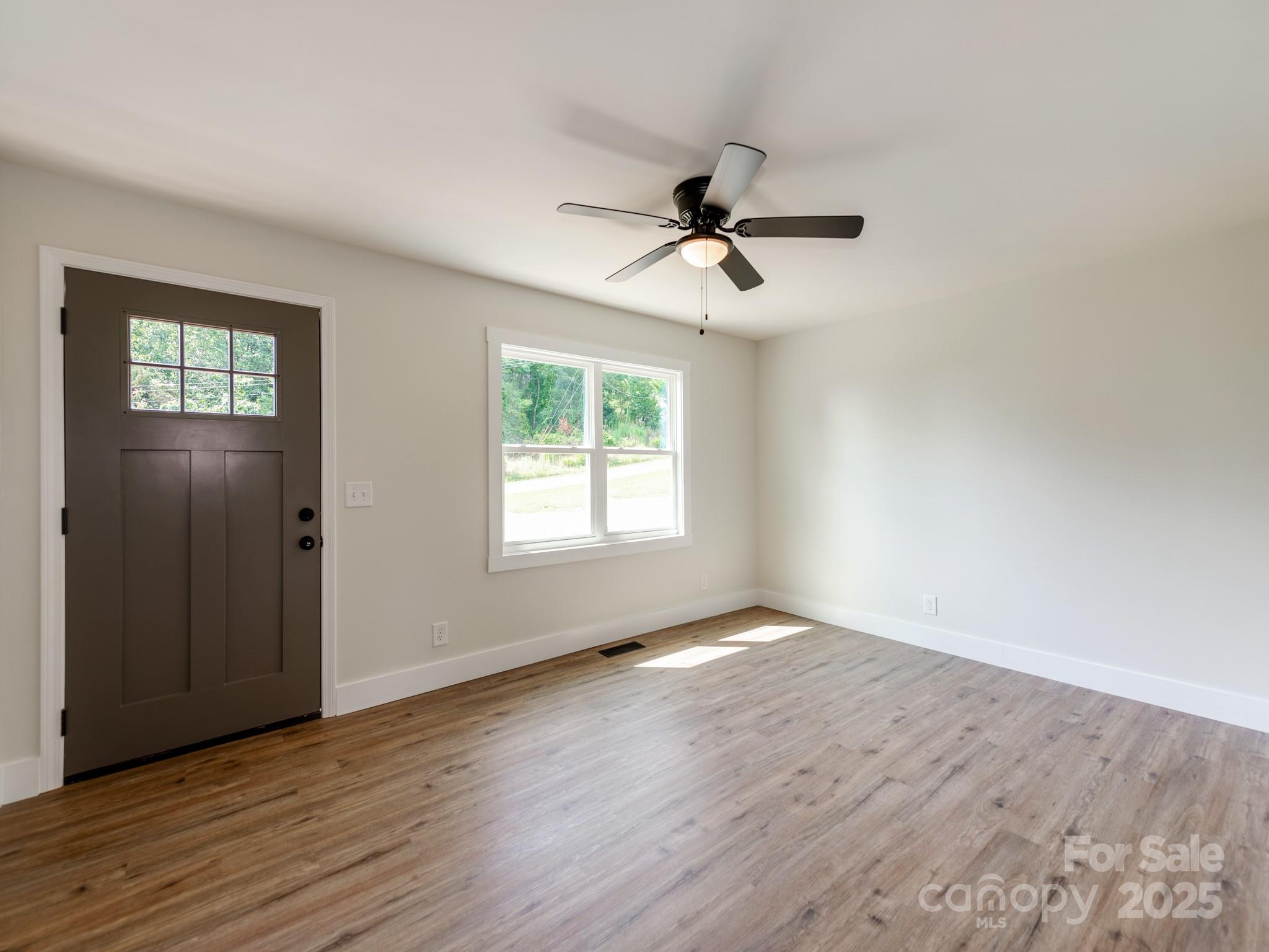 5404 Hope Road Vale, NC 28168 - Photo 24 of 28 a view of empty room with wooden floor and fan