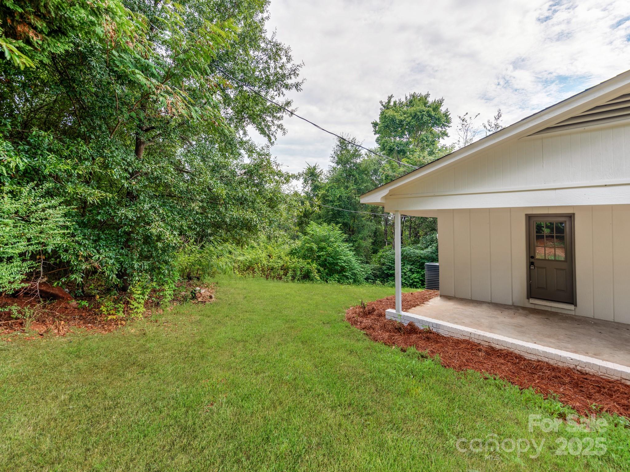 5404 Hope Road Vale, NC 28168 - Photo 25 of 28 a view of a backyard with table and chairs and potted plants