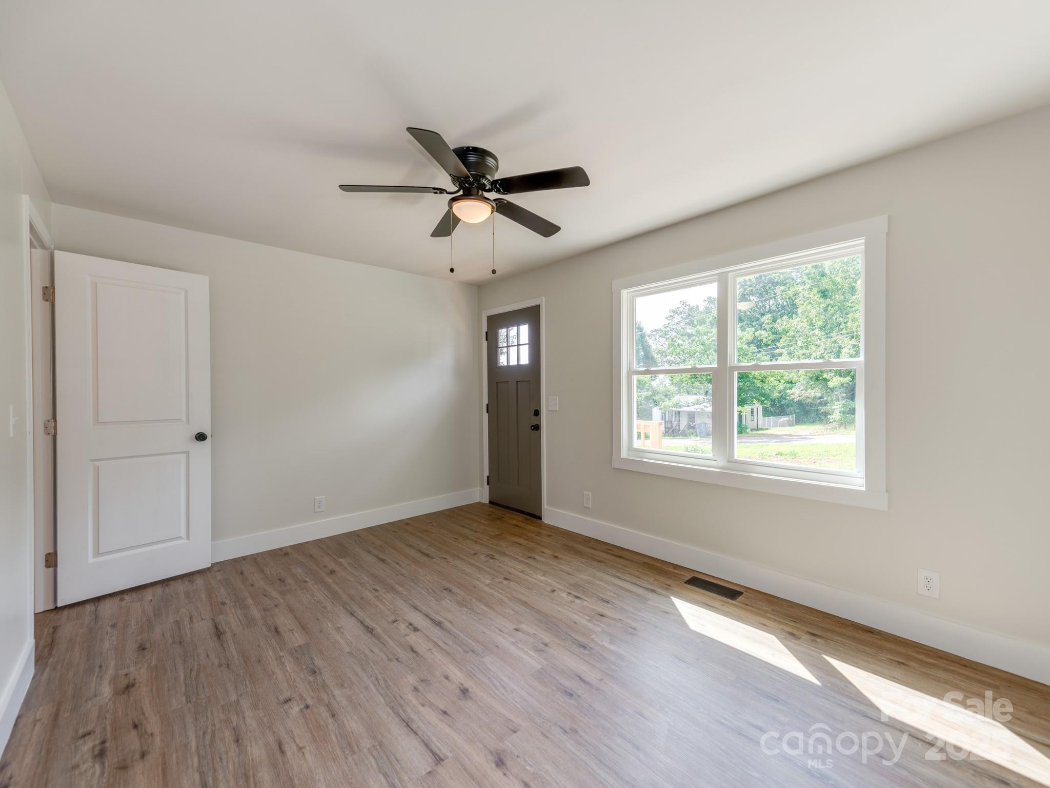 5404 Hope Road Vale, NC 28168 - Photo 8 of 28 a view of empty room with wooden floor and fan