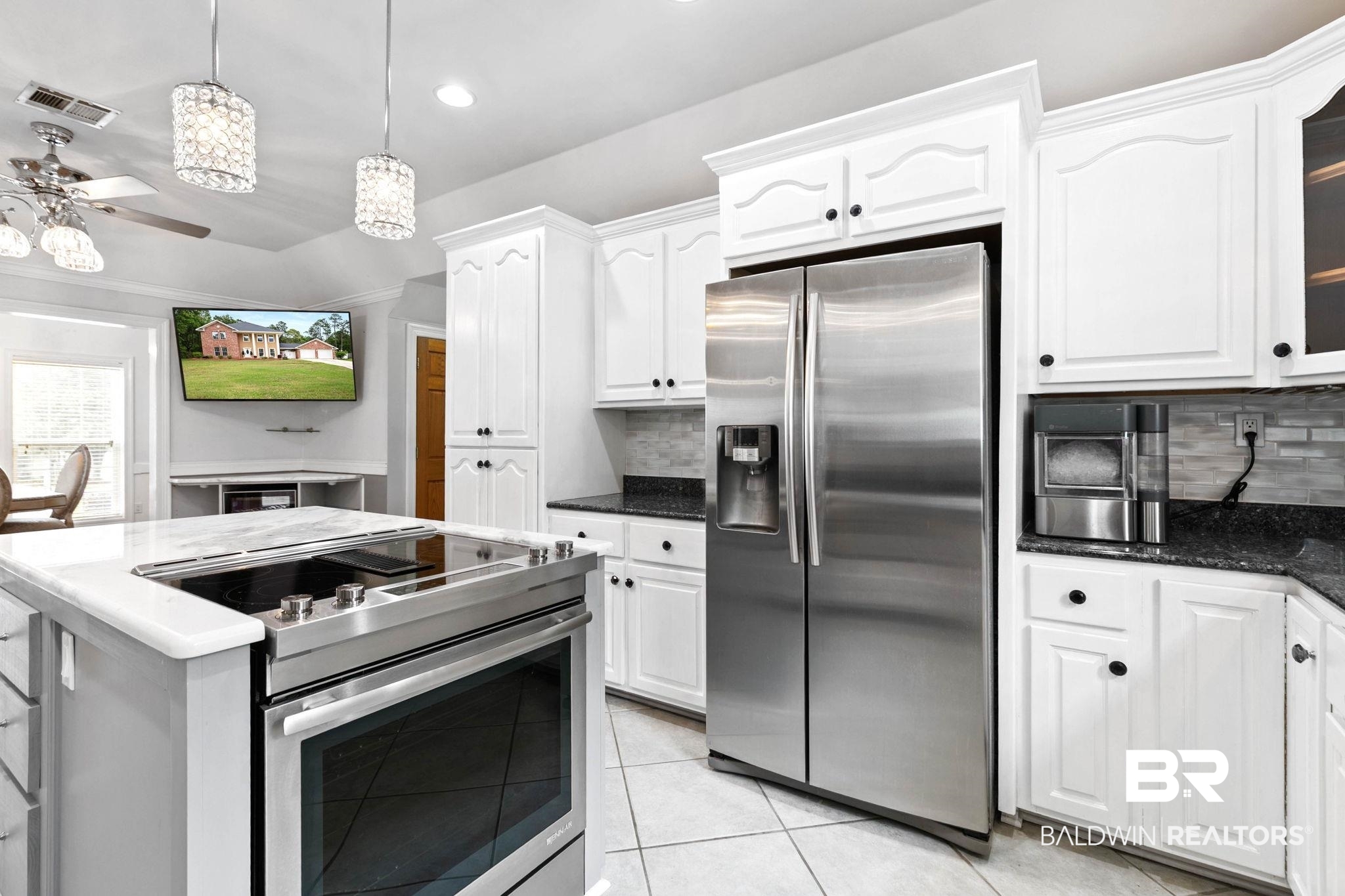 2 Speckle Trout Route Daphne, AL 36527 - Photo 18 of 61 Kitchen with stainless steel appliances, white cabinets, decorative light fixtures, dark stone countertops, and light tile patterned floors