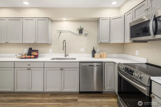 a kitchen with a sink stove and cabinets