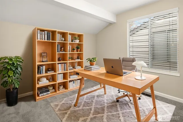 a workspace with furniture and a potted plant