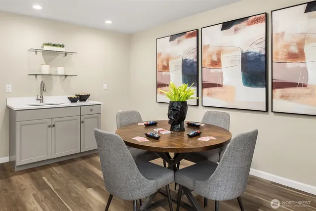 a dining room with furniture and a potted plant